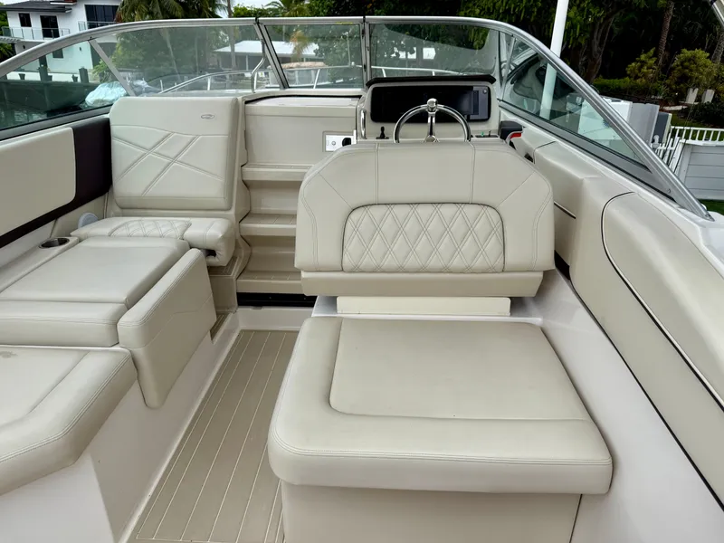Slide: The Image of 2021 Regal 26 XO boat interior with beige seating and modern dashboard. - 25