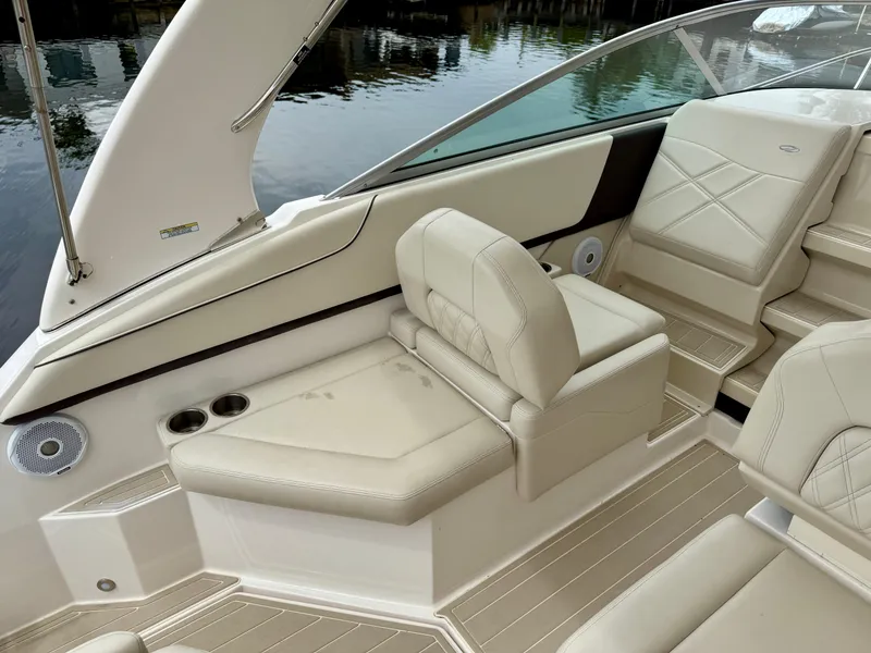 Slide: The Image of 2021 Regal 26 XO boat interior with beige leather seating and cup holders. - 27