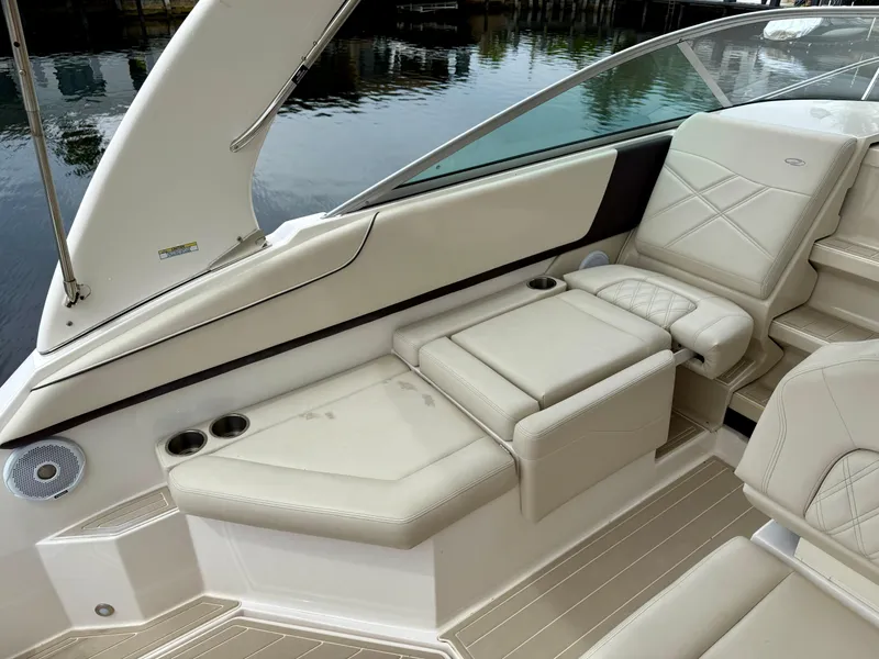 Slide: The Image of 2021 Regal 26 XO boat interior with beige seating and cup holders. - 28