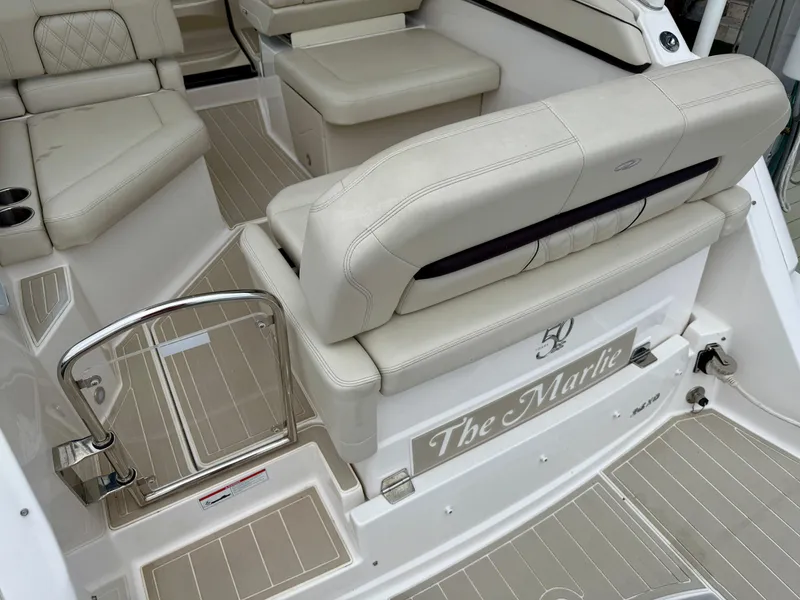 Slide: The Image of 2021 Regal 26 XO boat interior with beige seating and stainless steel railing. - 30