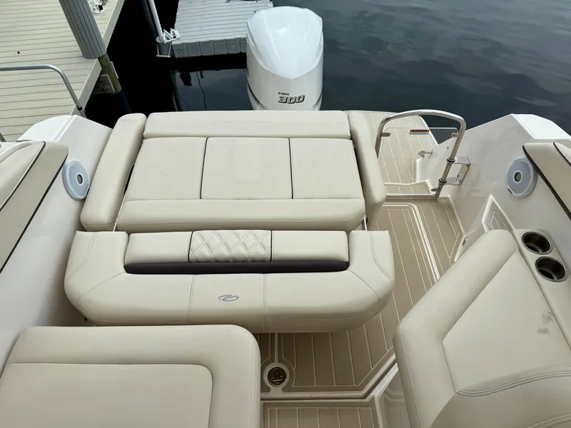Slide: The Image of 2021 Regal 26 XO boat interior with beige seating and deck, docked by water. - 37