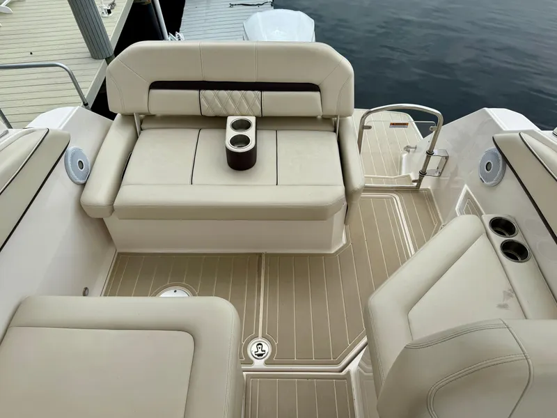 Slide: The Image of 2021 Regal 26 XO boat interior with beige seating and cup holders. - 38