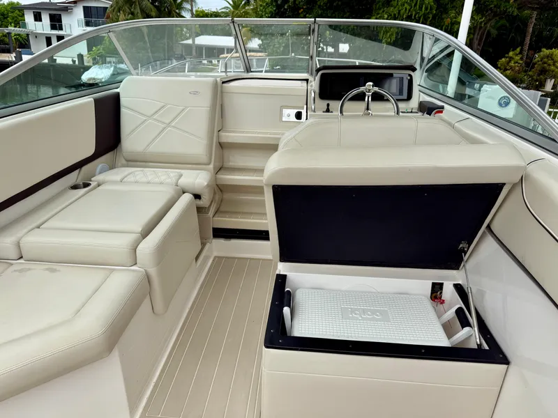Slide: The Image of 2021 Regal 26 XO boat interior with beige seating and storage compartment open. - 39