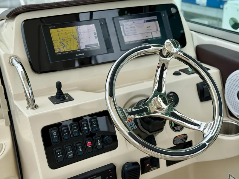 Slide: The Image of Steering console of 2021 Regal 26 XO boat with navigation screens and controls. - 42