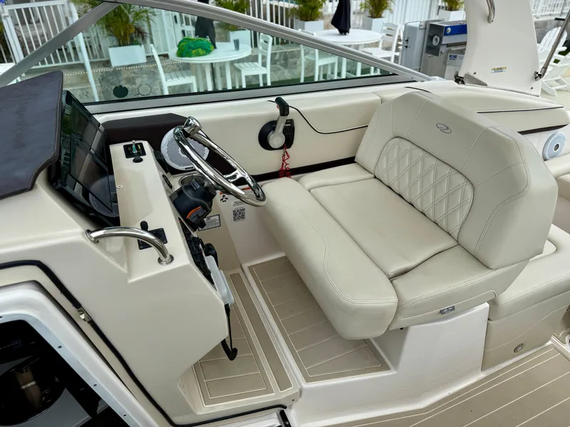 Slide: The Image of 2021 Regal 26 XO boat interior with steering wheel and beige seating. - 44