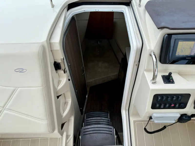 Slide: The Image of 2021 Regal 26 XO boat interior with cabin entrance and control panel. - 46
