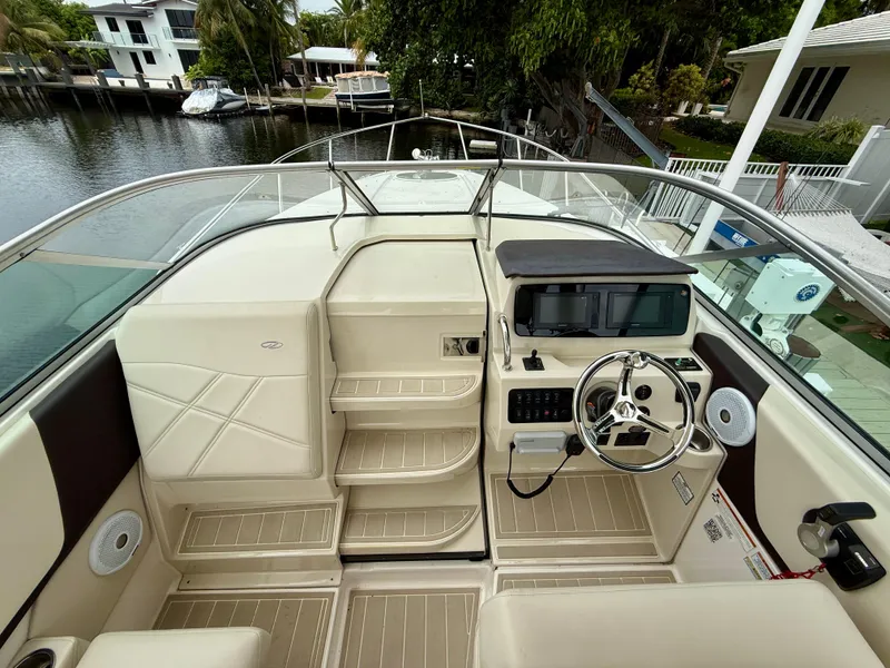 Slide: The Image of 2021 Regal 26 XO boat helm with modern controls and steering wheel. - 50