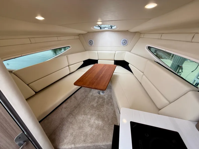 Slide: The Image of Luxurious interior of 2021 Regal 26 XO boat with plush seating and wooden table. - 51