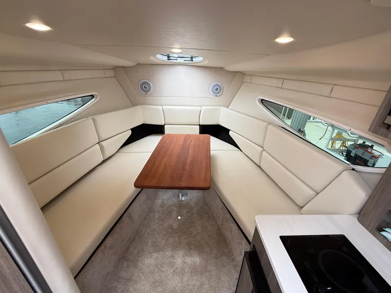 Slide: The Image of Luxurious interior of 2021 Regal 26 XO boat with plush seating and wooden table. - 52