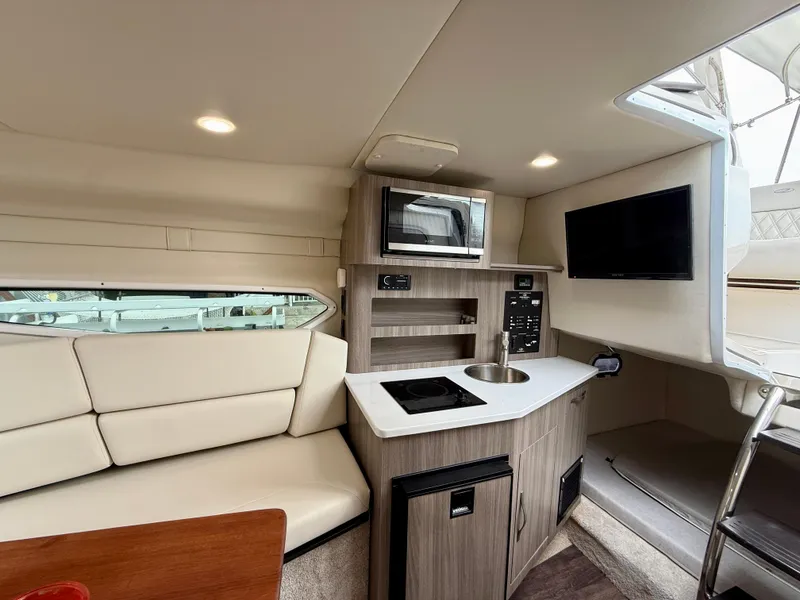 Slide: The Image of Luxurious interior of 2021 Regal 26 XO boat with kitchenette and seating area. - 54
