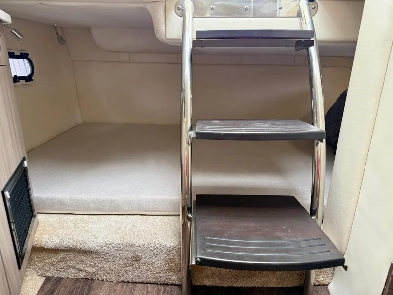 Slide: The Image of Interior cabin of 2021 Regal 26 XO boat with ladder and bed. - 57