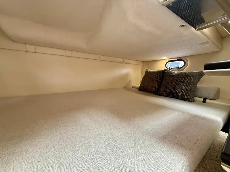 Slide: The Image of 2021 Regal 26 XO cabin interior with cozy bed and decorative pillows. - 60