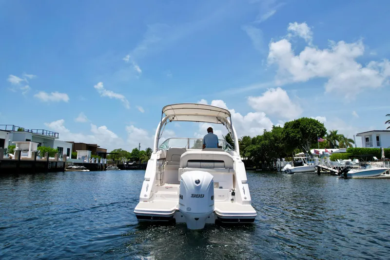 Slide: The Image of 2021 Regal 26 XO boat cruising on a sunny day in a scenic waterway. - 8