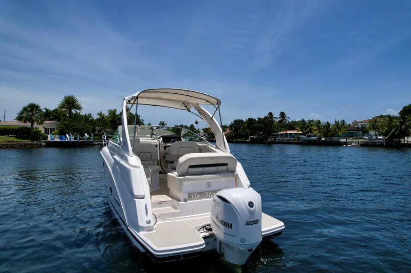 Slide: The Image of 2021 Regal 26 XO boat on a sunny day, cruising on a calm waterway. - 9