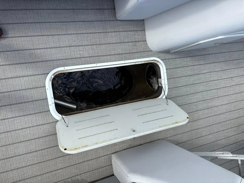 Slide: The Image of 2024 Bentley Pontoons Legacy QSB storage compartment on a sleek, modern deck. - 10