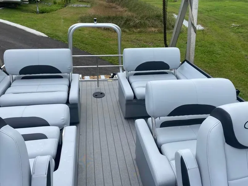 Slide: The Image of 2024 Bentley Pontoons Legacy QSB interior with luxurious seating on a grassy background. - 13