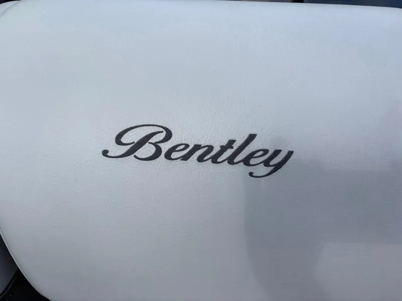 Slide: The Image of 2024 Bentley Pontoons Legacy QSB logo on white leather upholstery. - 17
