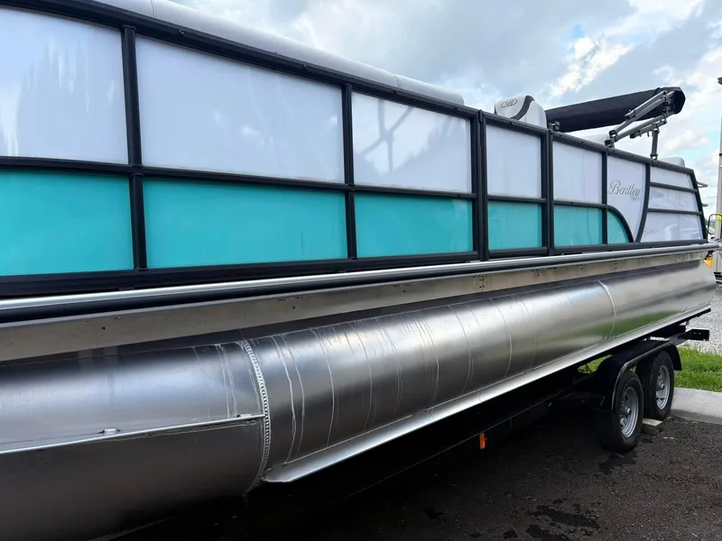 Slide: The Image of 2024 Bentley Pontoons Legacy QSB pontoon boat on trailer, side view. - 3
