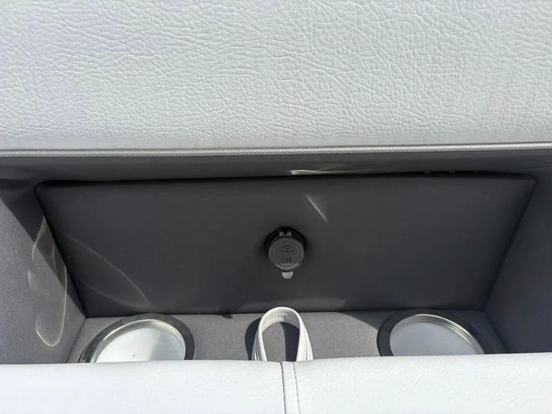 Slide: The Image of 2024 Bentley Pontoons Legacy QSB interior with USB port and cup holders. - 6