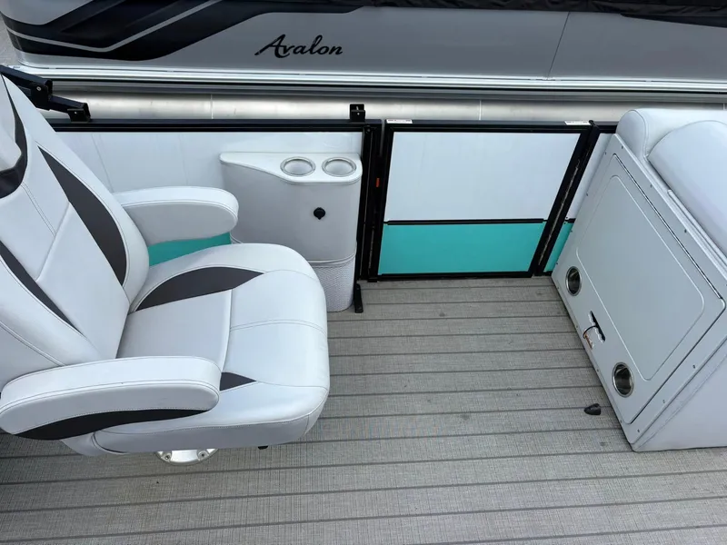 Slide: The Image of 2024 Bentley Pontoons Legacy QSB interior with white seating and storage compartments. - 9