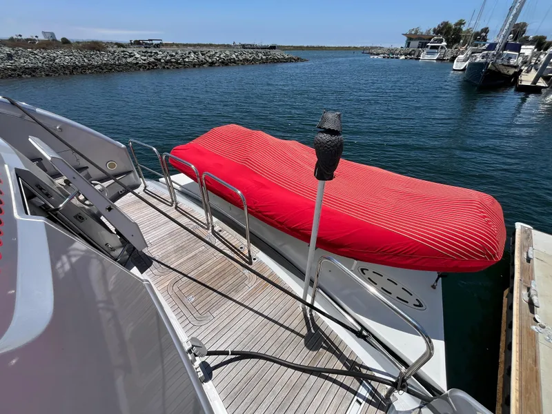 Slide: The Image of Astondoa 95GLX 2001 yacht deck with red-covered equipment, docked in a marina. - 10