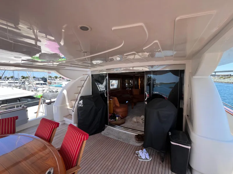 Slide: The Image of Luxurious 2001 Astondoa 95GLX yacht deck with elegant seating and marina view. - 11