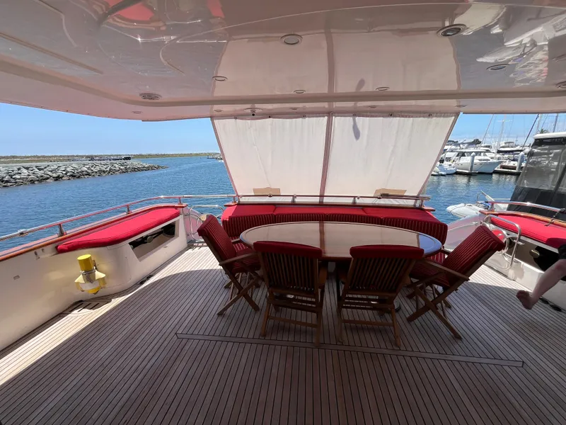 Slide: The Image of Astondoa 95GLX 2001 yacht deck with dining area, overlooking marina and ocean. - 12