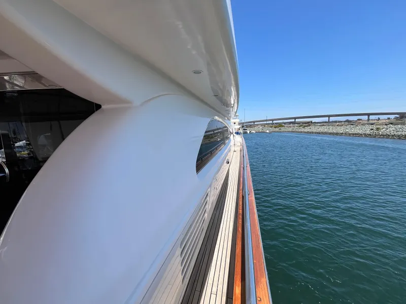 Slide: The Image of Side view of 2001 Astondoa 95GLX yacht on calm water under clear blue sky. - 13