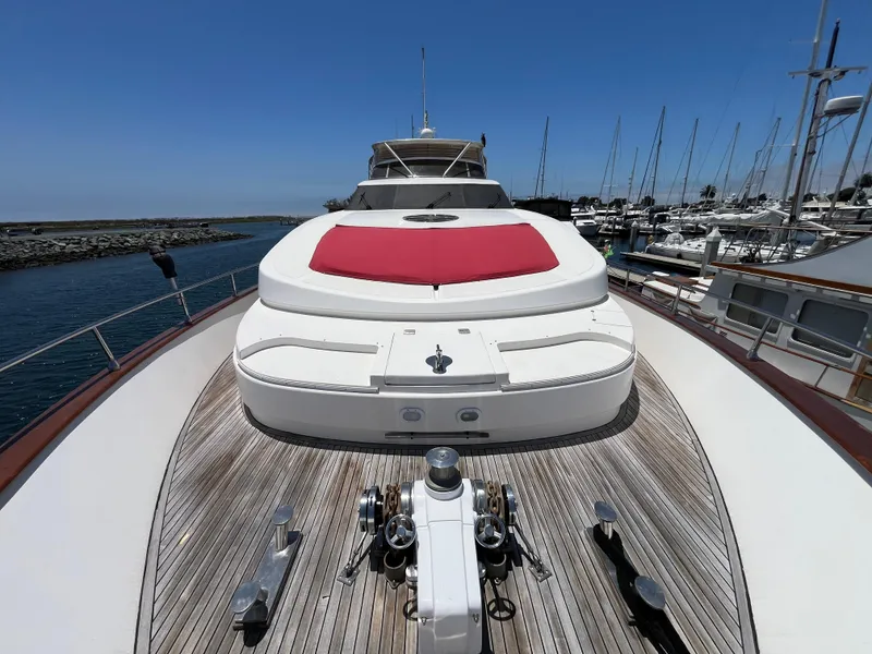 Slide: The Image of Astondoa 95GLX 2001 yacht with red sunpad, docked in marina under clear blue sky. - 14
