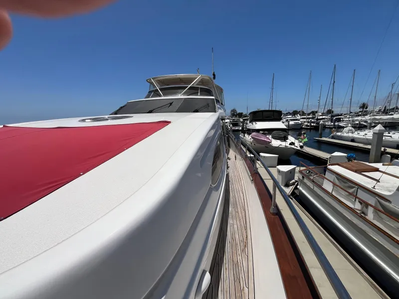 Slide: The Image of Astondoa 95GLX yacht from 2001 docked at a marina under clear blue skies. - 19
