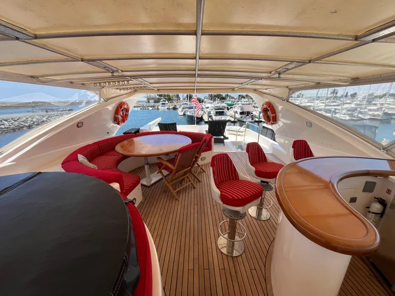 Slide: The Image of Luxurious 2001 Astondoa 95GLX yacht deck with seating, bar, and marina view. - 22