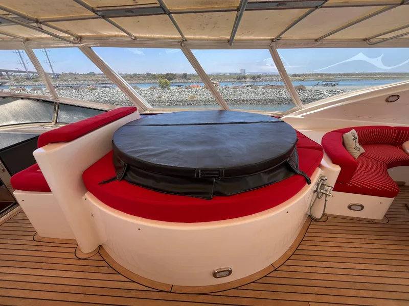 Slide: The Image of Luxurious 2001 Astondoa 95GLX yacht interior with red seating and covered hot tub. - 23