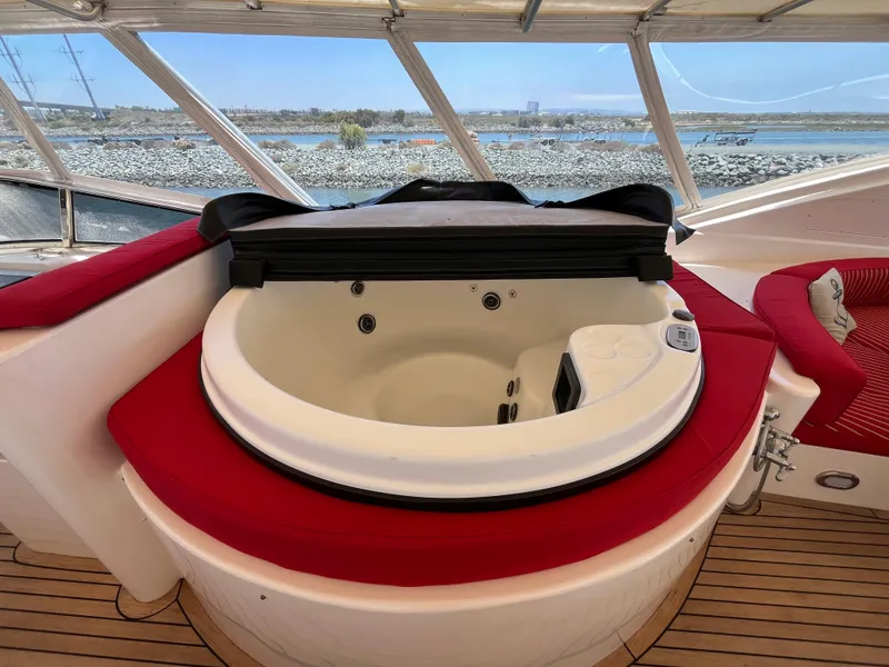 Slide: The Image of Luxurious jacuzzi on 2001 Astondoa 95GLX yacht with red seating and scenic water view. - 24