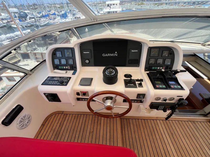 Slide: The Image of Cockpit of 2001 Astondoa 95GLX yacht with Garmin navigation system and wooden steering wheel. - 26