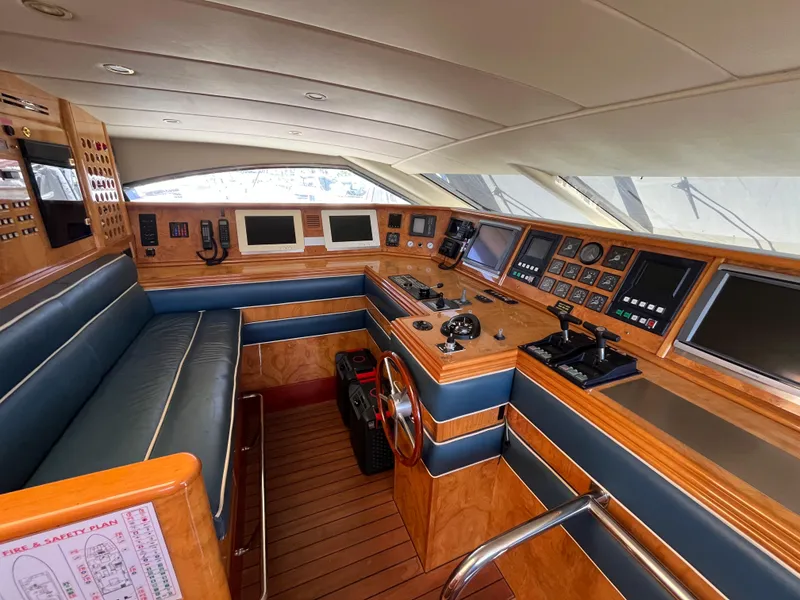 Slide: The Image of Luxurious 2001 Astondoa 95GLX yacht cockpit with advanced navigation systems and elegant wood finish. - 32