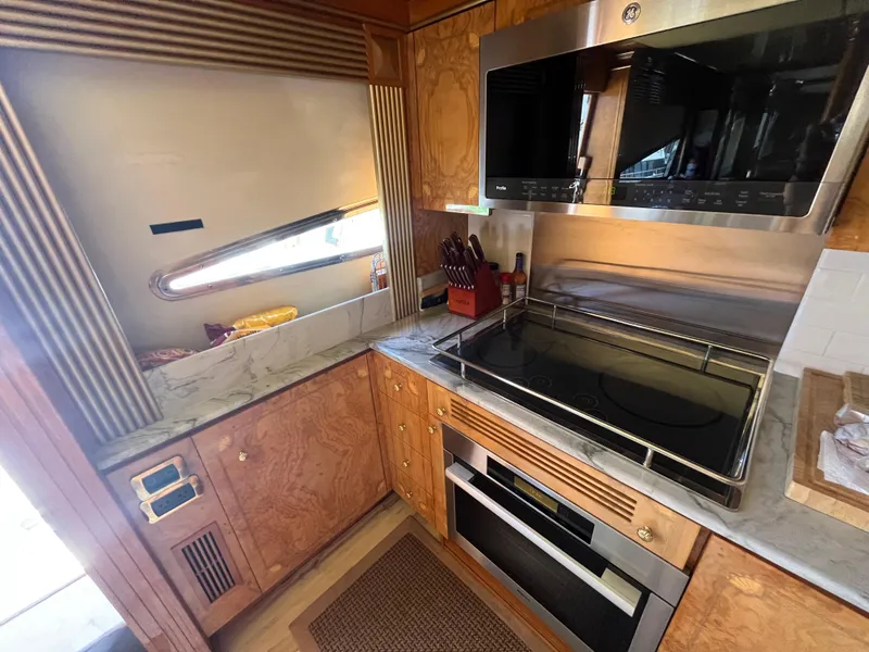 Slide: The Image of Luxurious kitchen in 2001 Astondoa 95GLX yacht with modern appliances and wood cabinetry. - 43