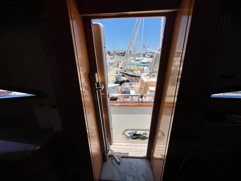 Slide: The Image of View from inside a 2001 Astondoa 95GLX yacht, looking out to a marina. - 45