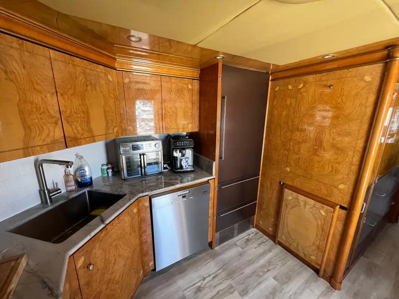 Slide: The Image of Luxurious kitchen in 2001 Astondoa 95GLX yacht with wood cabinetry and modern appliances. - 46