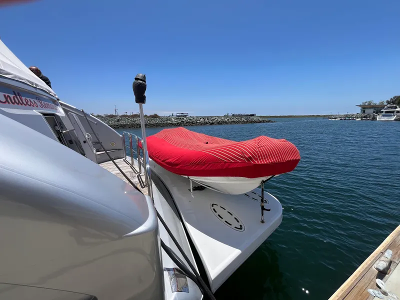 Slide: The Image of Astondoa 95GLX yacht (2001) docked with covered boat on deck, clear blue sky. - 7