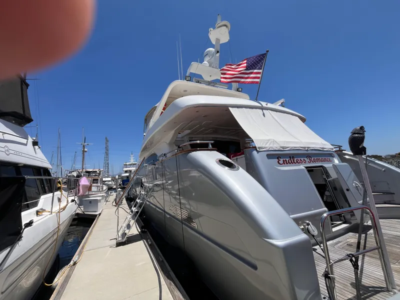 Slide: The Image of Astondoa 95GLX yacht from 2001 docked, featuring "Endless Romance" name and American flag. - 8