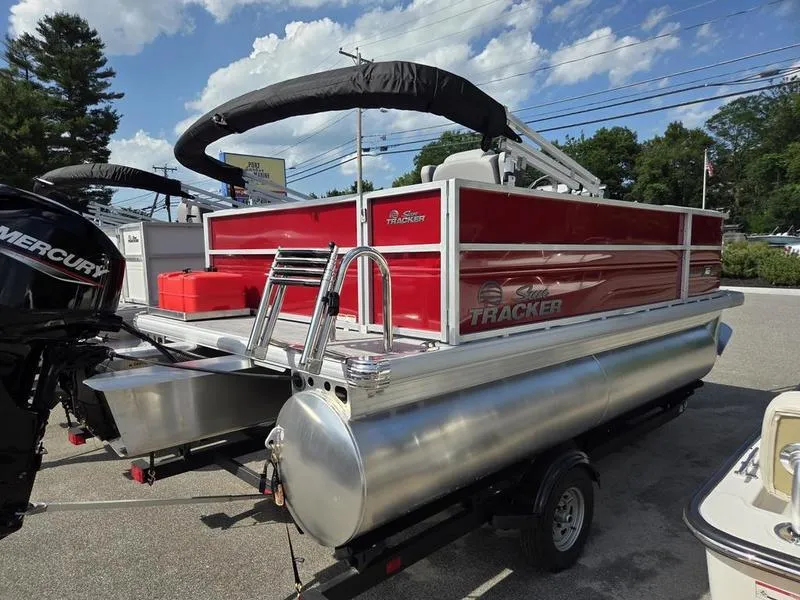 Slide: The Image of 2026 Sun Tracker PB 16 DLX pontoon boat with red exterior and Mercury engine. - 11