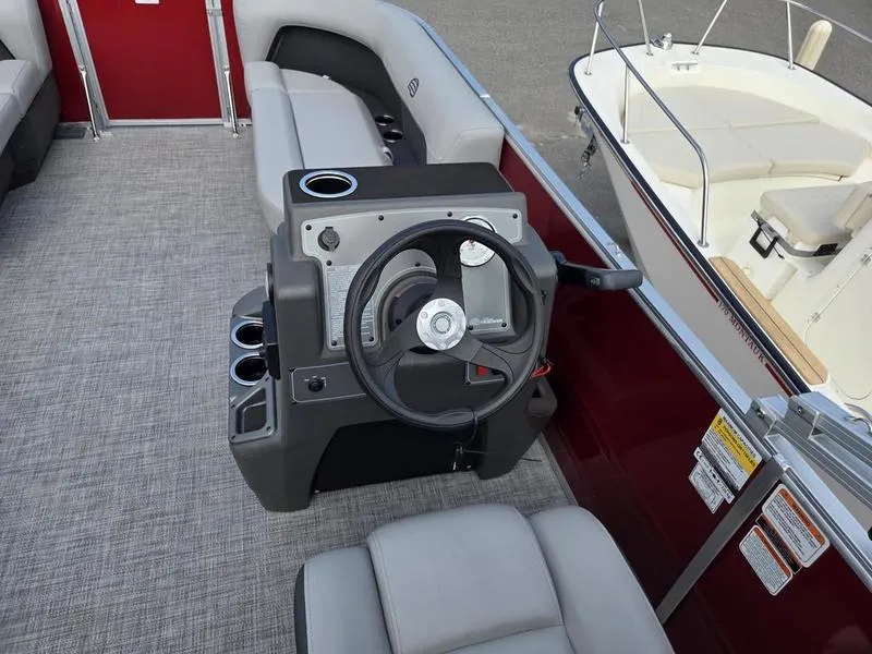 Slide: The Image of 2026 Sun Tracker PB 16 DLX boat interior with steering console and seating. - 5