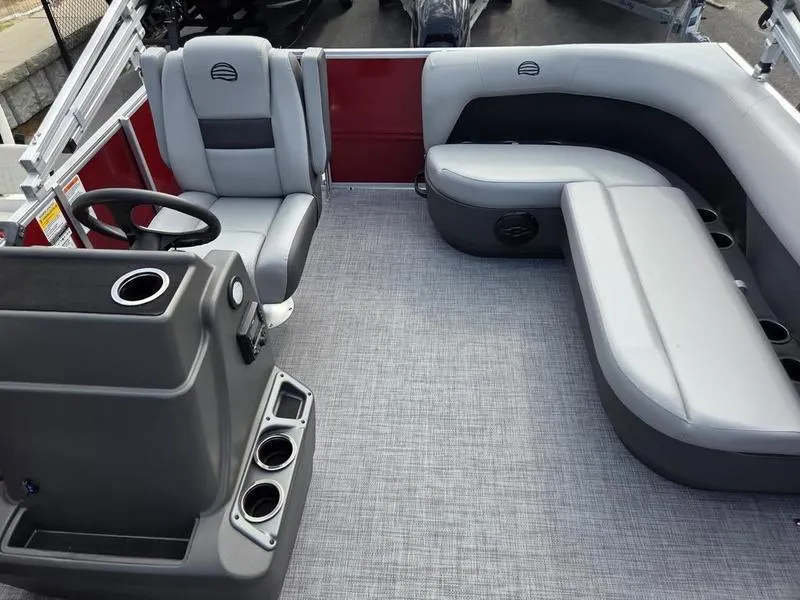 Slide: The Image of 2026 Sun Tracker PB 16 DLX pontoon boat interior with gray seating and steering console. - 7