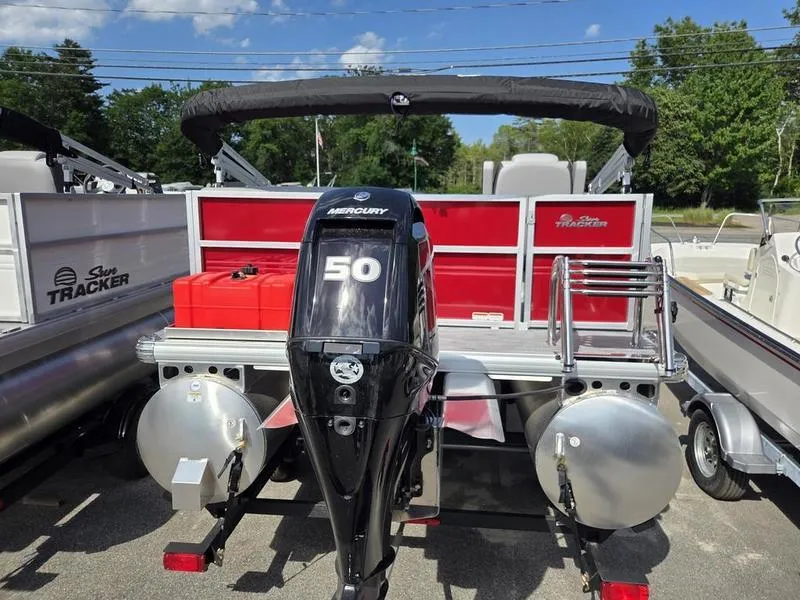 Slide: The Image of 2026 Sun Tracker PB 16 DLX pontoon boat with Mercury 50 engine, docked outdoors. - 9