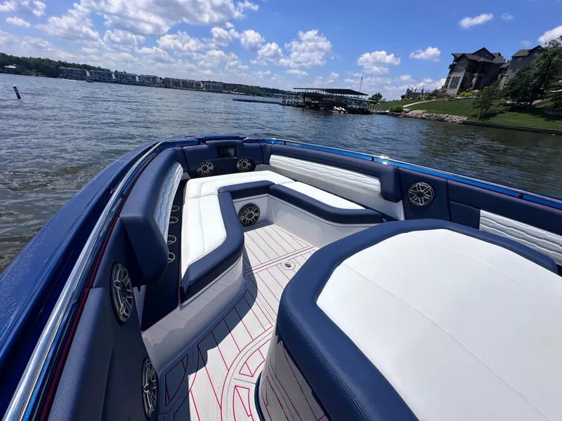 Slide: The Image of Four powerful outboard motors on a 2024 Cigarette 42 Auroris boat at a dock. - 26