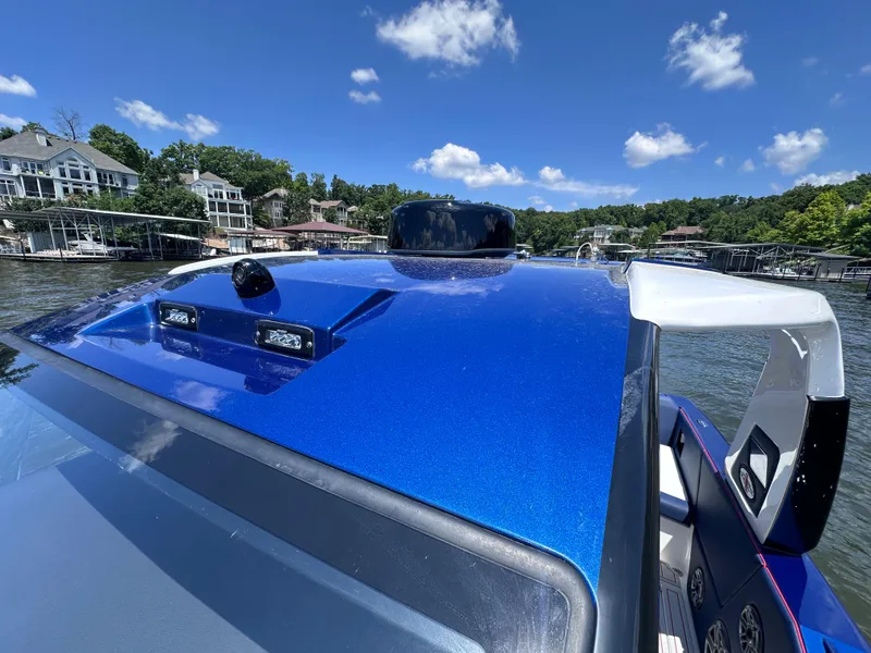 Slide: The Image of 2024 Cigarette 42 Auroris boat with blue metallic finish on a sunny day. - 38