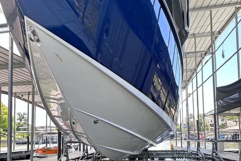 Slide: The Image of 2024 Cigarette 42 Auroris boat in dock, showcasing sleek blue and white hull design. - 40