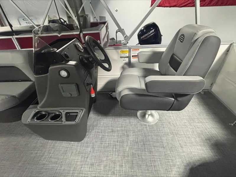 Slide: The Image of 2026 Sun Tracker PB 16 DLX boat interior with steering console and captain's chair. - 3