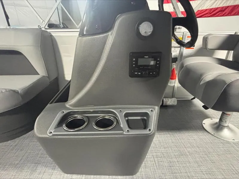 Slide: The Image of 2026 Sun Tracker PB 16 DLX boat console with cup holders and control panel. - 5
