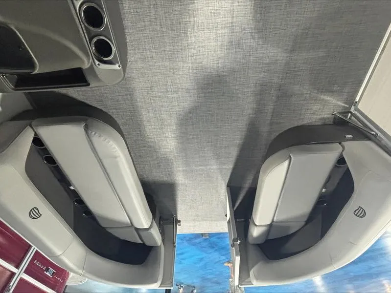 Slide: The Image of 2026 Sun Tracker PB 16 DLX boat interior with gray seating and cup holders. - 7